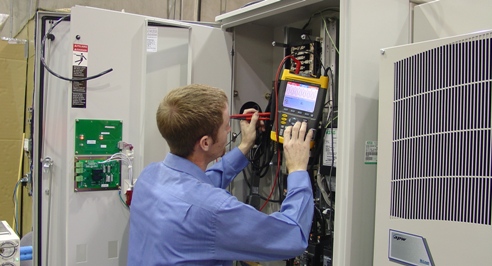A Purcell Systems technical field-expert tests integration of telecommunications equipment Purcell Systems technical field-expert tests integration of telecommunications equipment